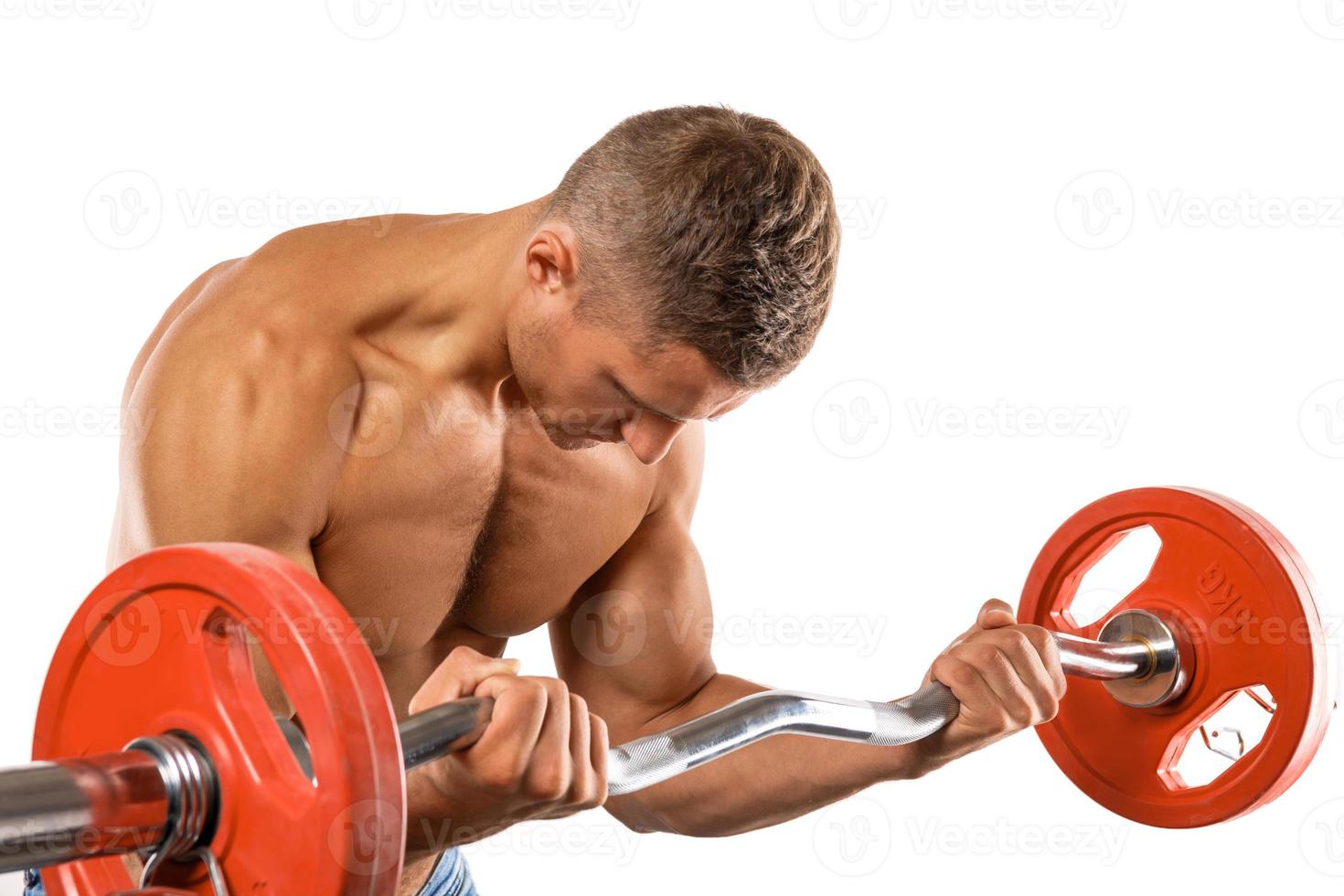 Young muscular man doing bicep barbell curl exercise photo