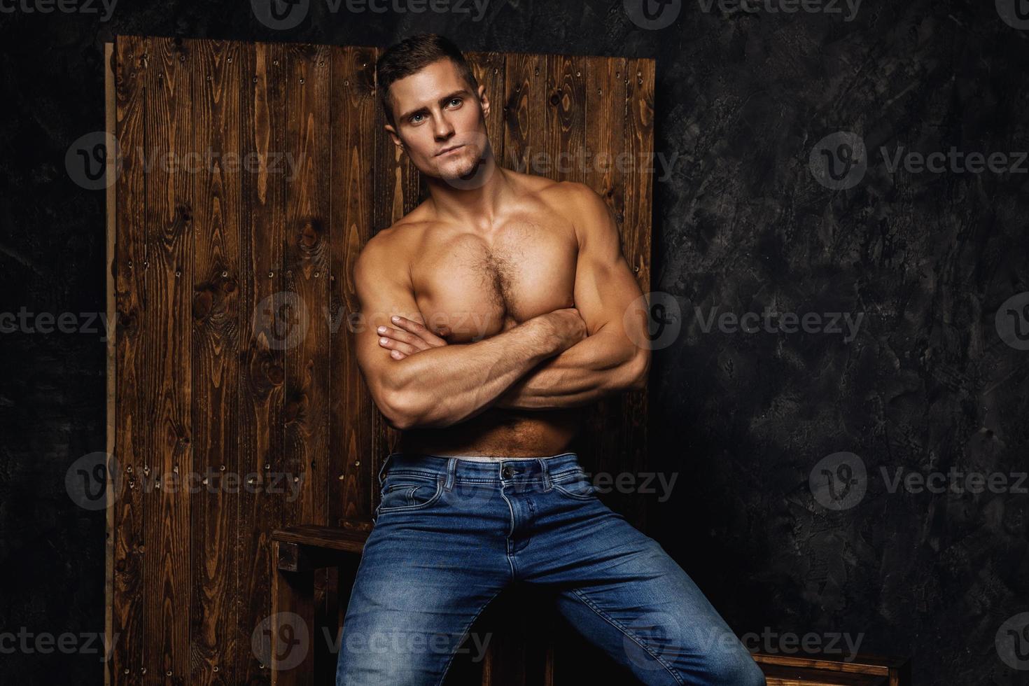 Portrait of handsome muscular and sexy man wearing jeans photo