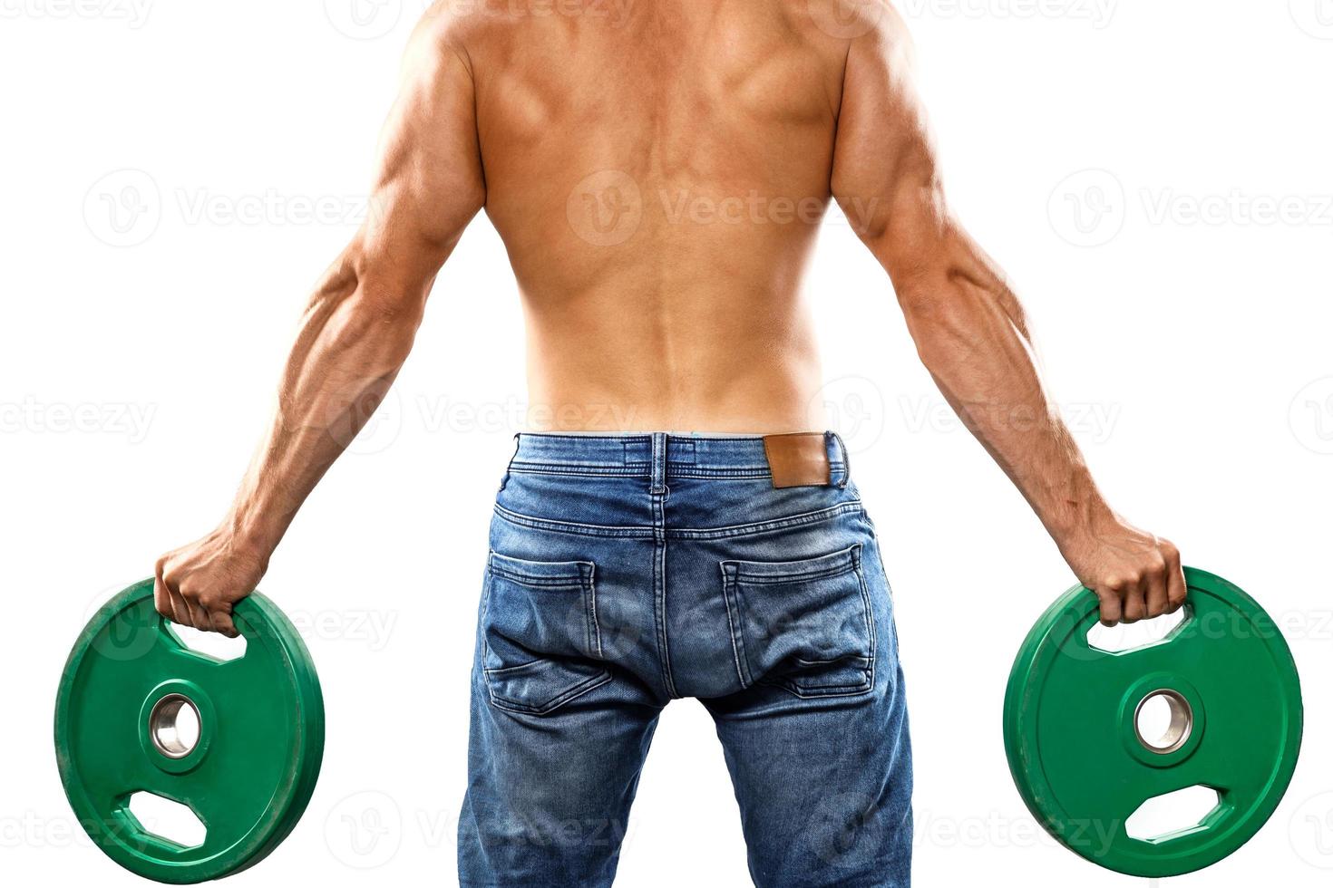 Young muscular man is posing with barbell weight plate photo
