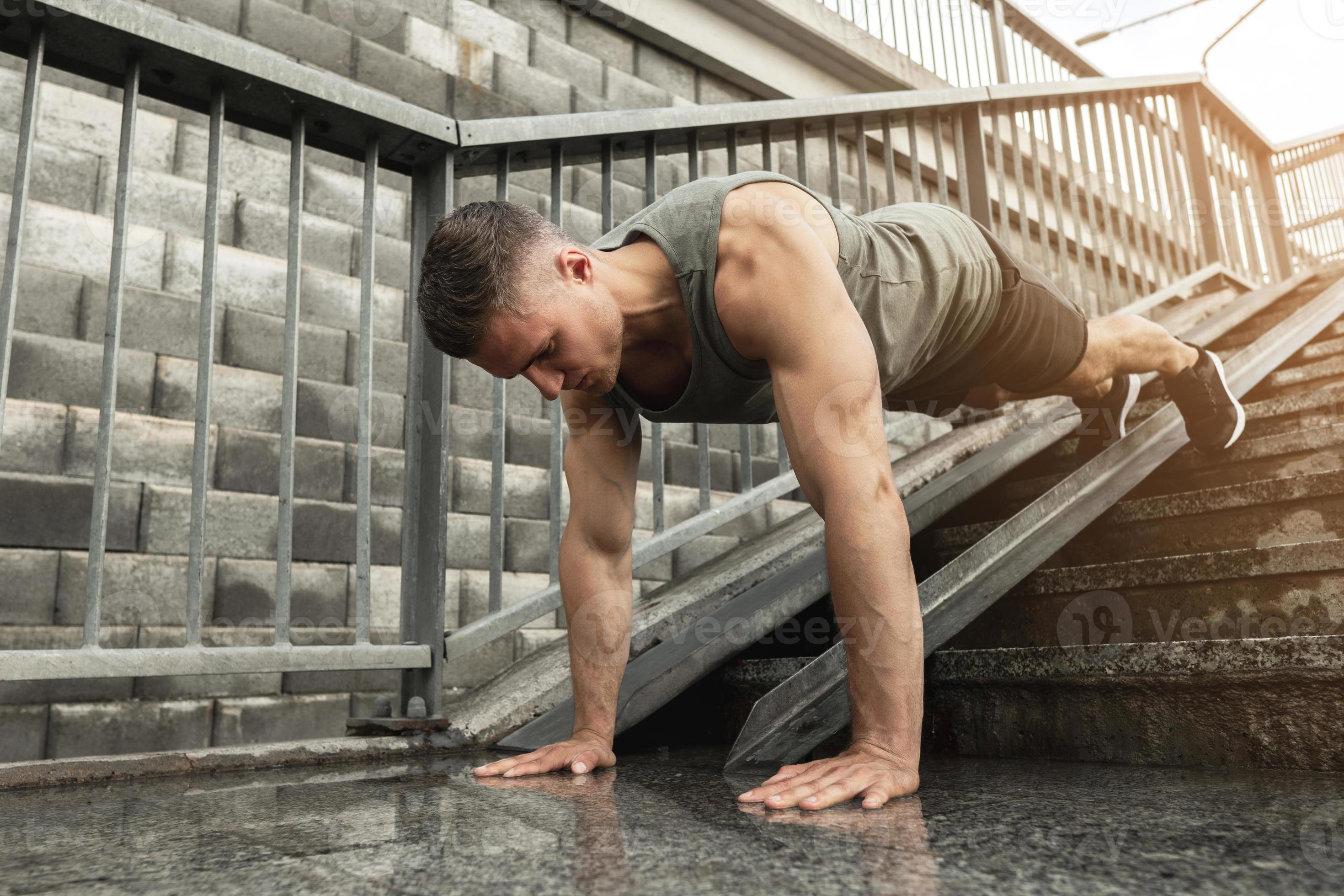 Muscular man is doing pushups during calisthenic workout on a street 16235030 Stock Photo at