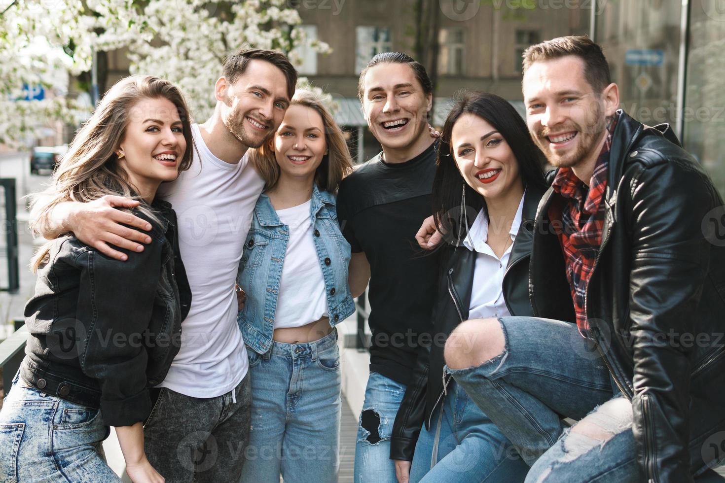 Group of best friends are having fun outdoors. Young people are happy to see each other during a meeting. photo