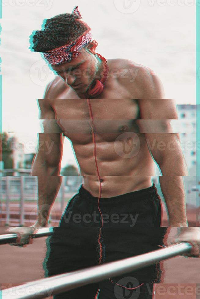 Muscular man on the street with a noisy VHS glitch effect photo