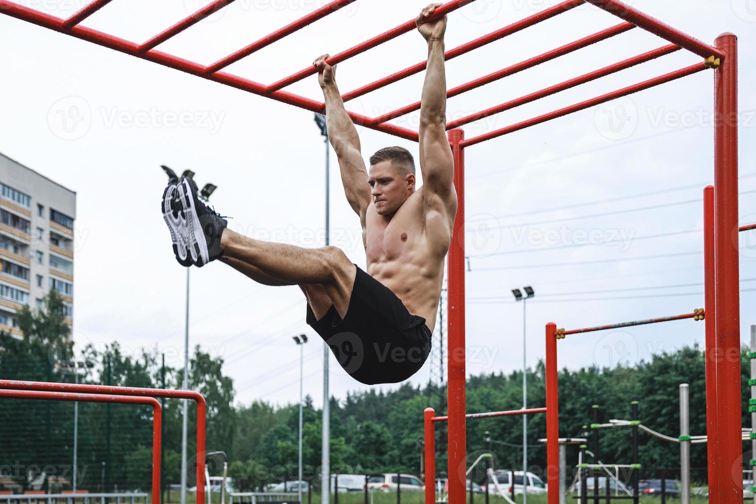 Muscular man during his workout on the street photo