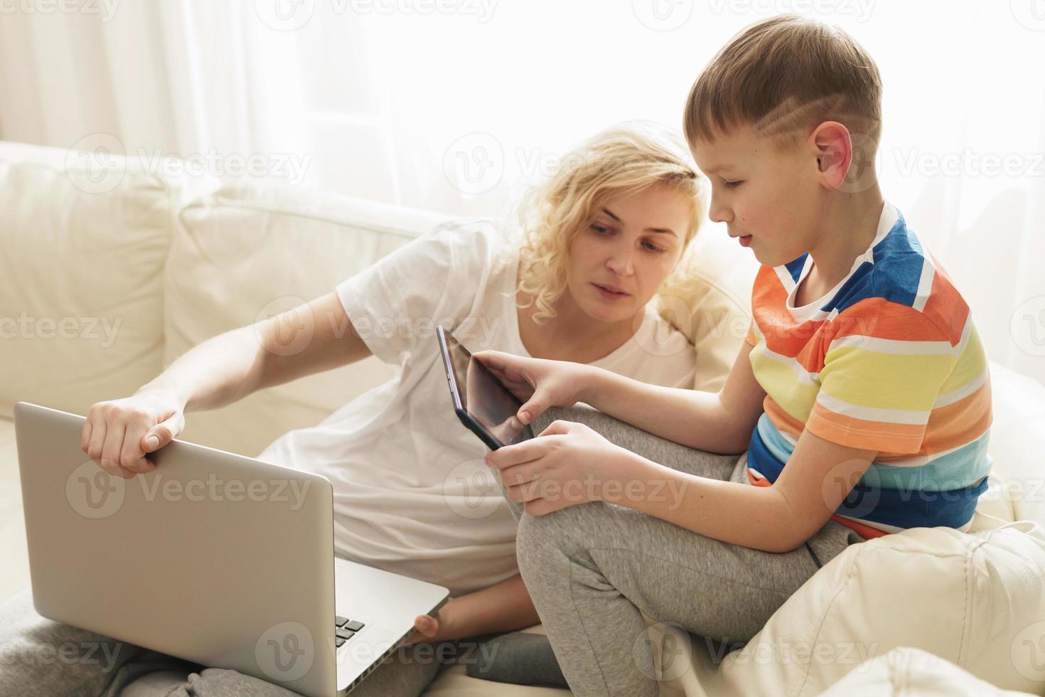 Boy is learning how to use a tablet pc photo