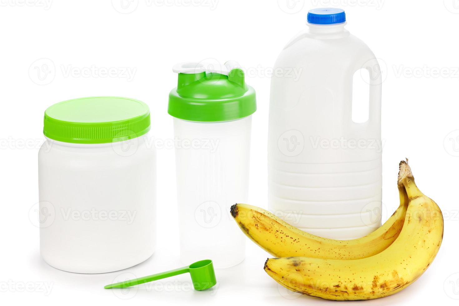 Protein shaker, big bottle of milk and bananas photo