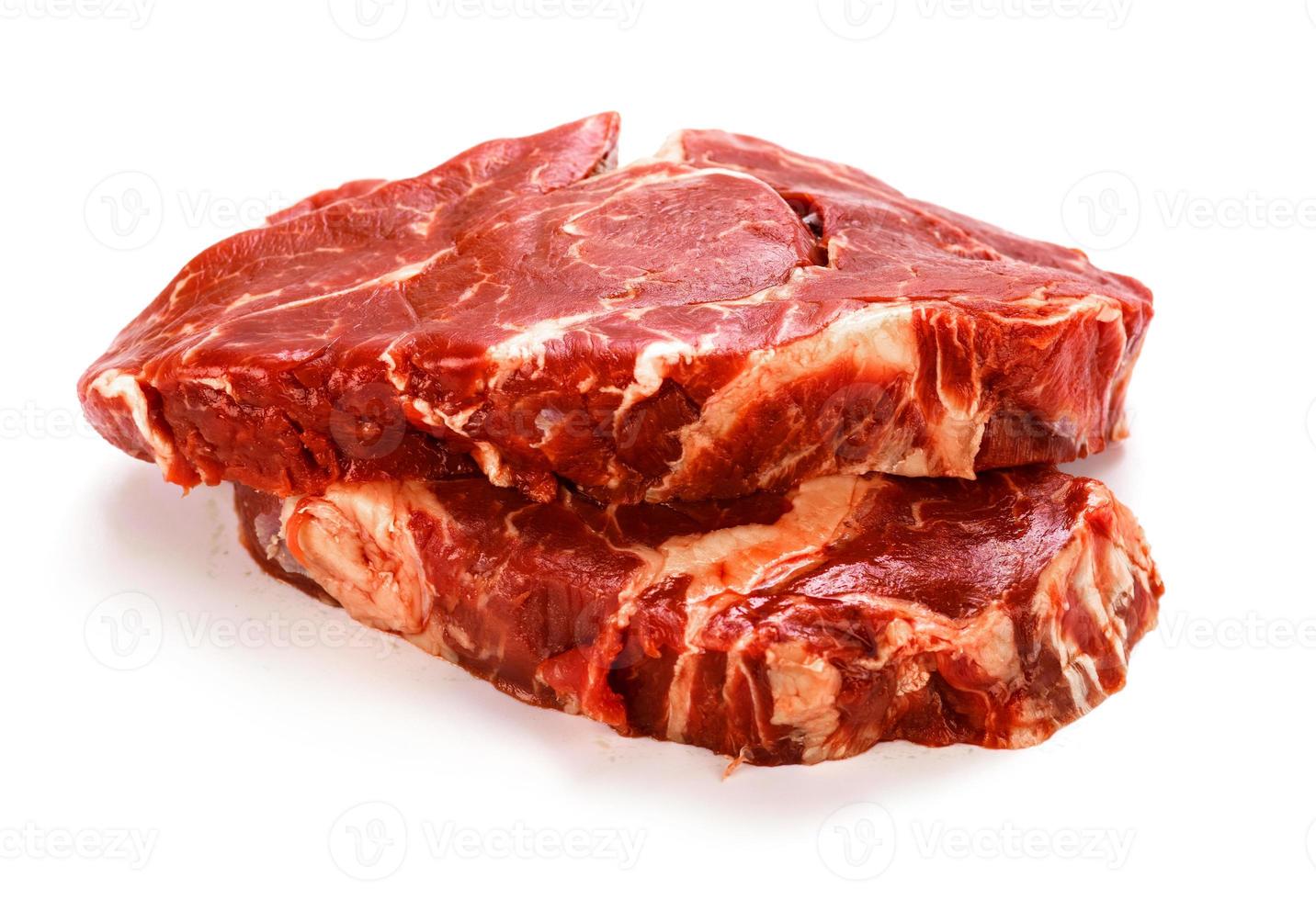 Raw pieces of beef meat on white photo