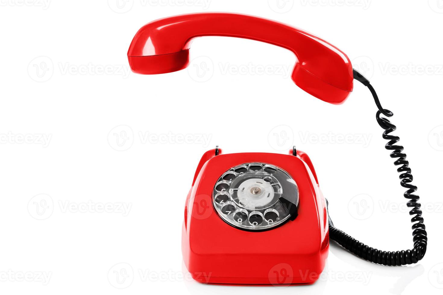 Retro red telephone on white background photo