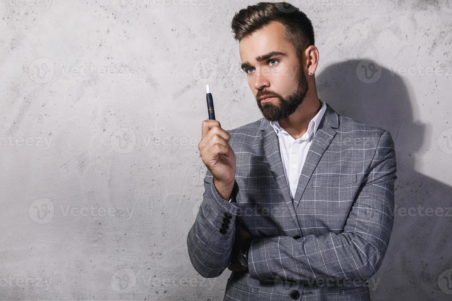 Handsome man smoking a tobacco heathing system photo