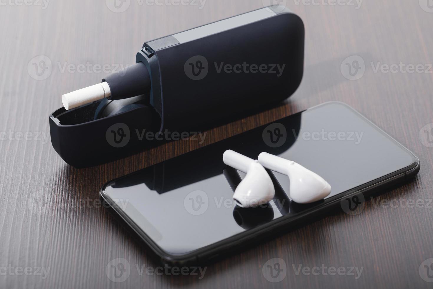 Tobacco heating system, wireless earphones and smartphone photo