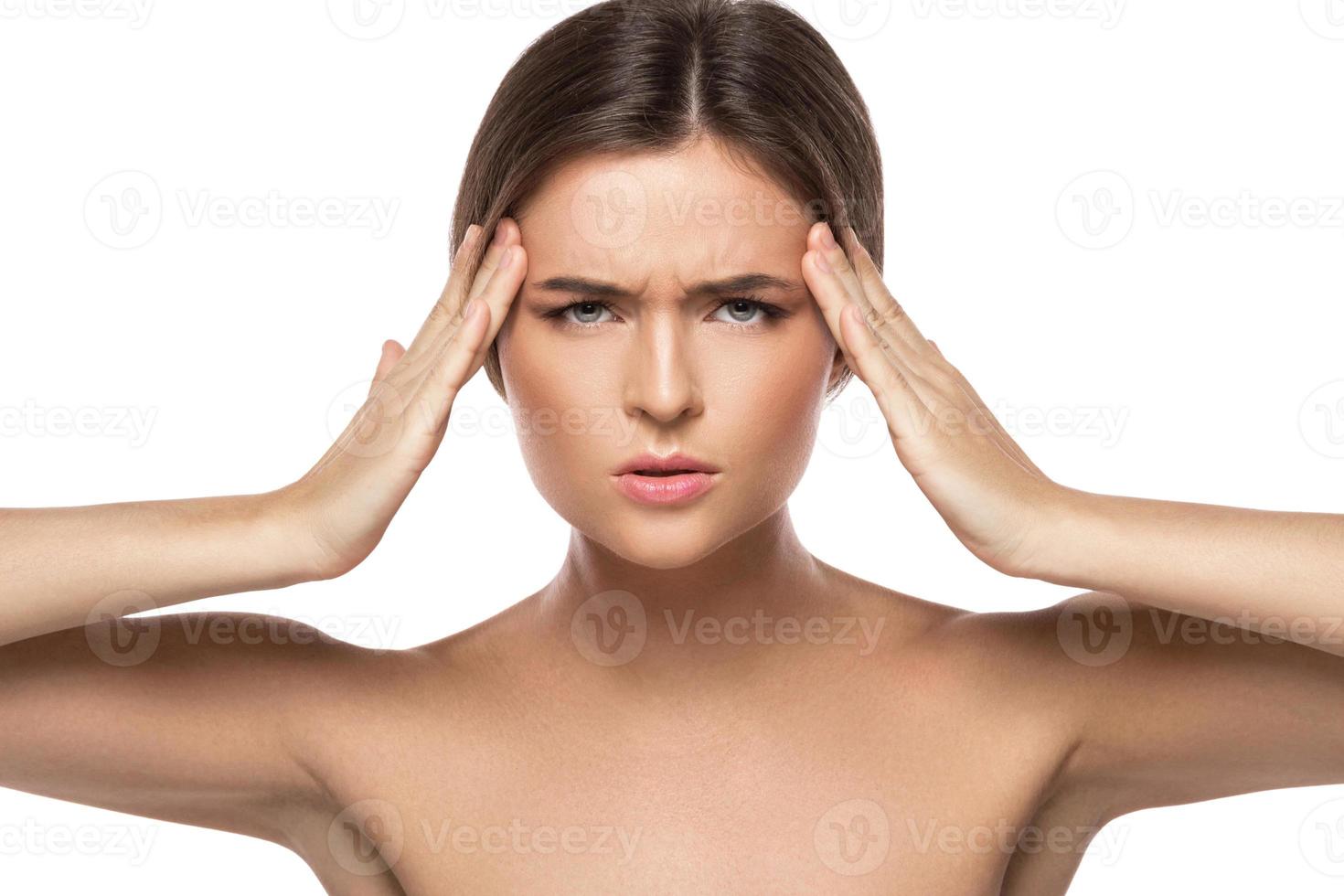 Woman with a headache on white background photo