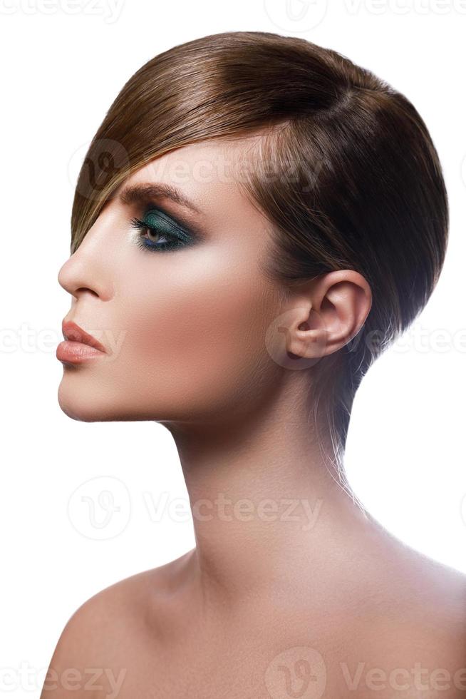 Sexy model in stylish image with sleek hair covering one eye and beautiful green eyeshadows on another photo