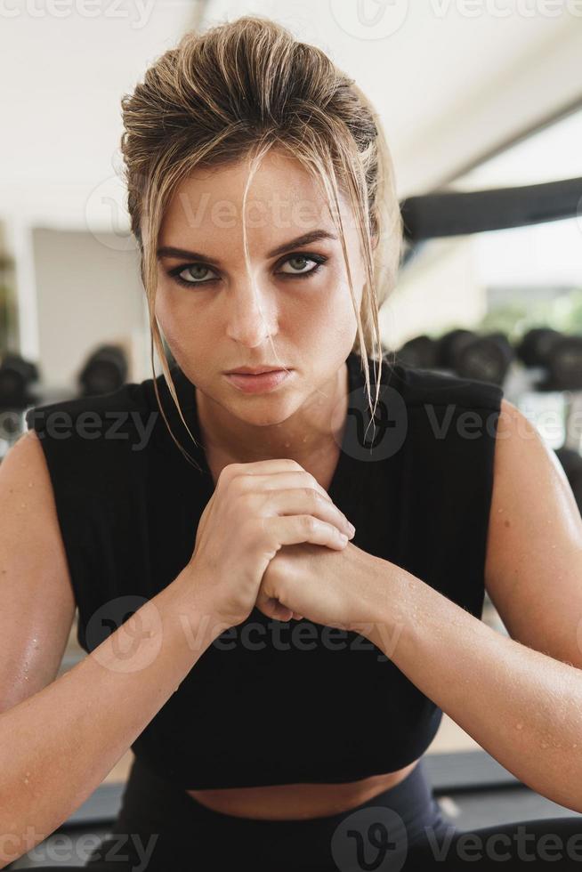 Portrait of young athletic woman in gym photo