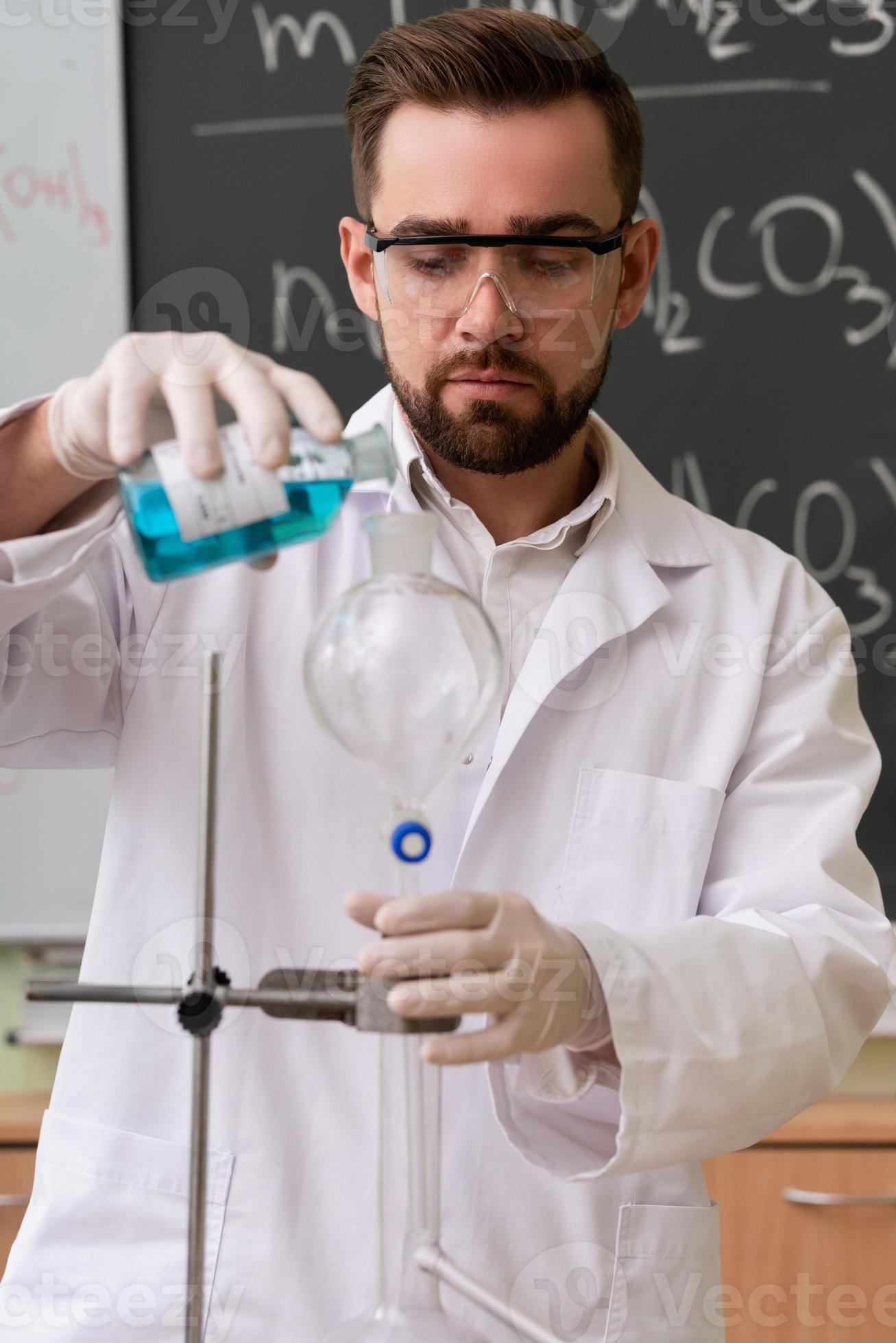 Scientist is pouring substance into the condenser in a laboratory