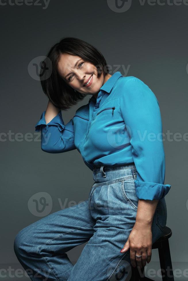 Beautiful middle aged woman wearing blue shirt photo
