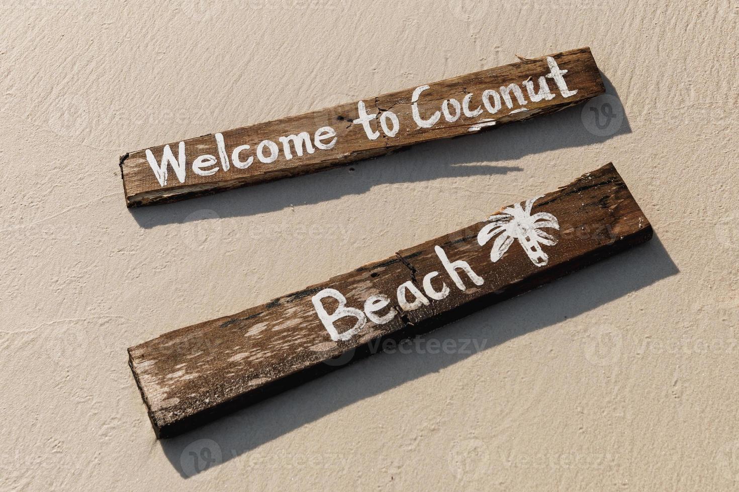 Wooden sign with lettering on the beach photo