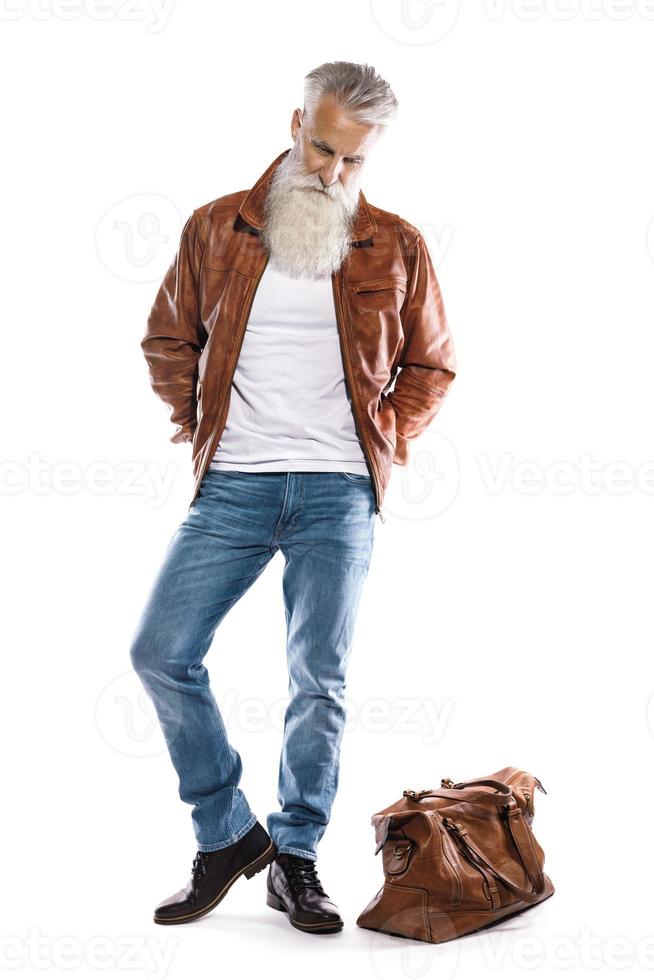 Handsome bearded senior man with leather bag and jacket on white background photo
