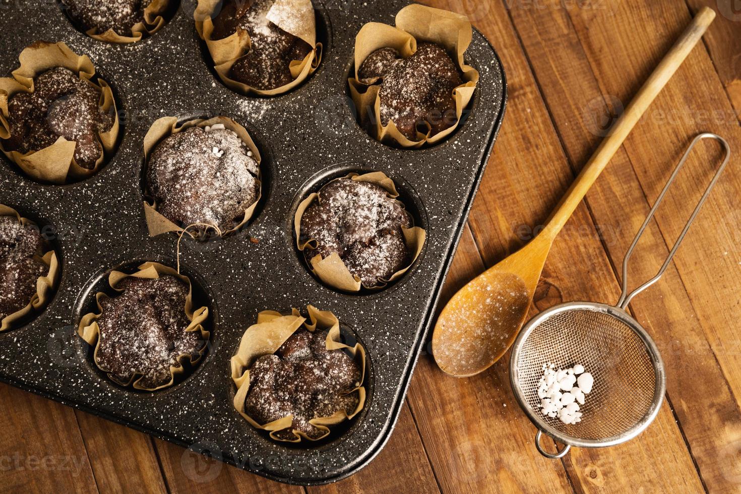 Baking tin with a tasty chocolate muffins photo