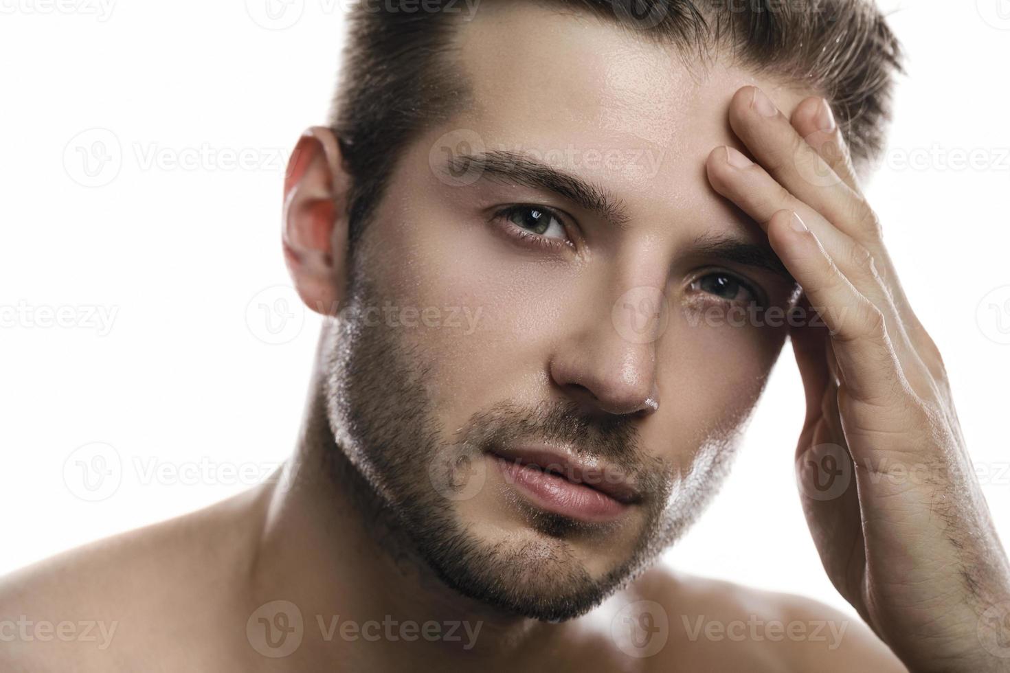 Young and handsome man on white background photo