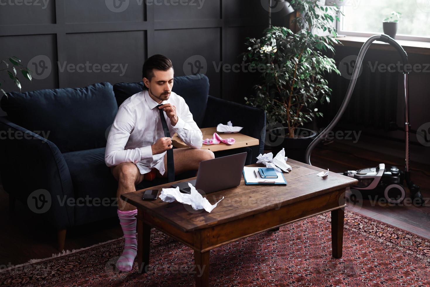 Businessman without pants during job interview or online meeting during distant work from home photo