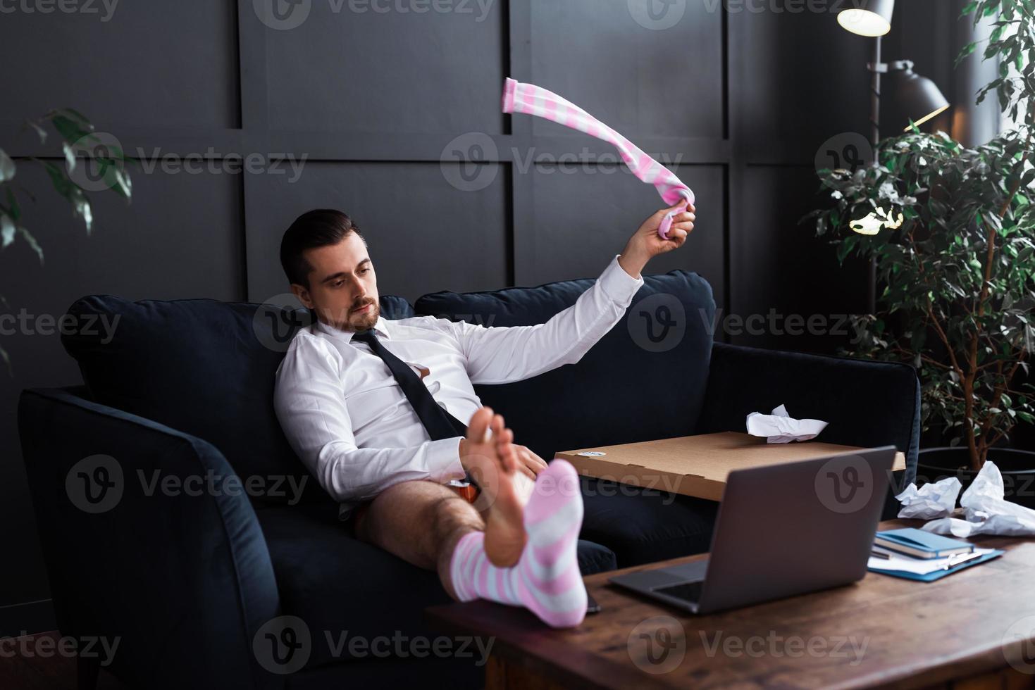 Lazy businessman without pants is working from home photo