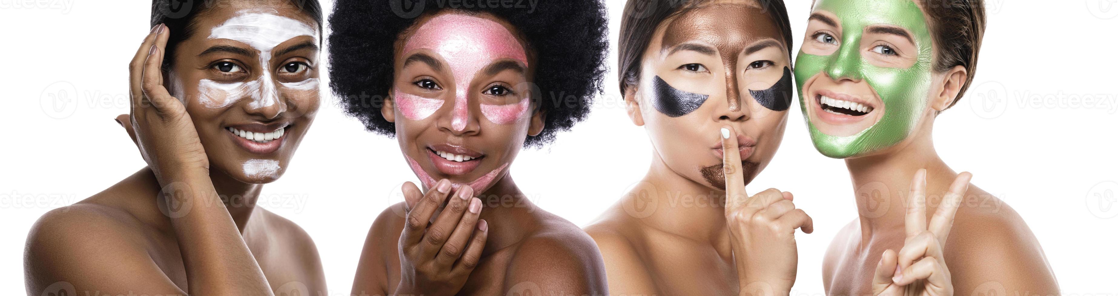 Beautiful multi-ethnic group of girls with colorful peel-off masks on their faces photo