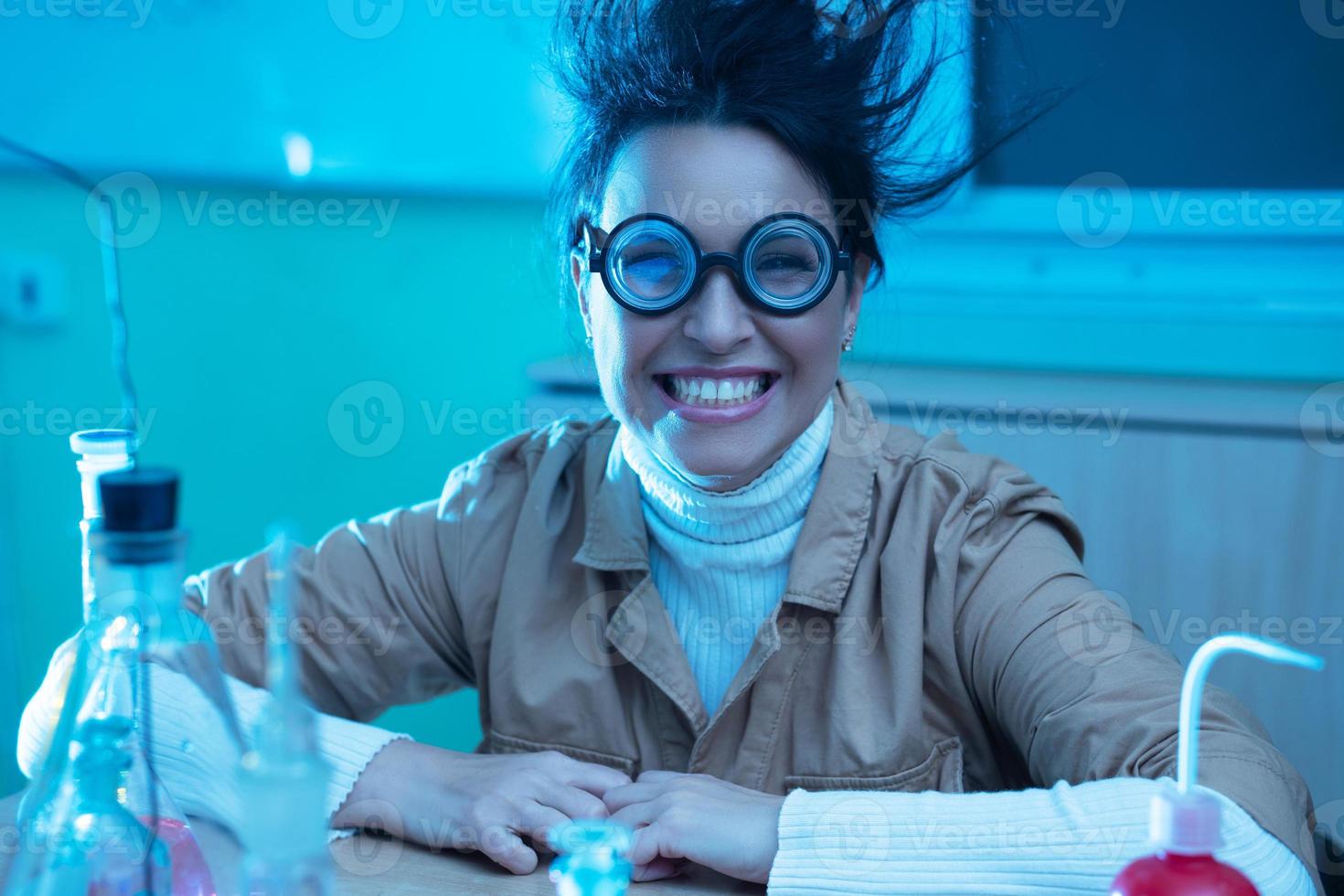 Cheerful smiling chemistry teacher in funny image photo