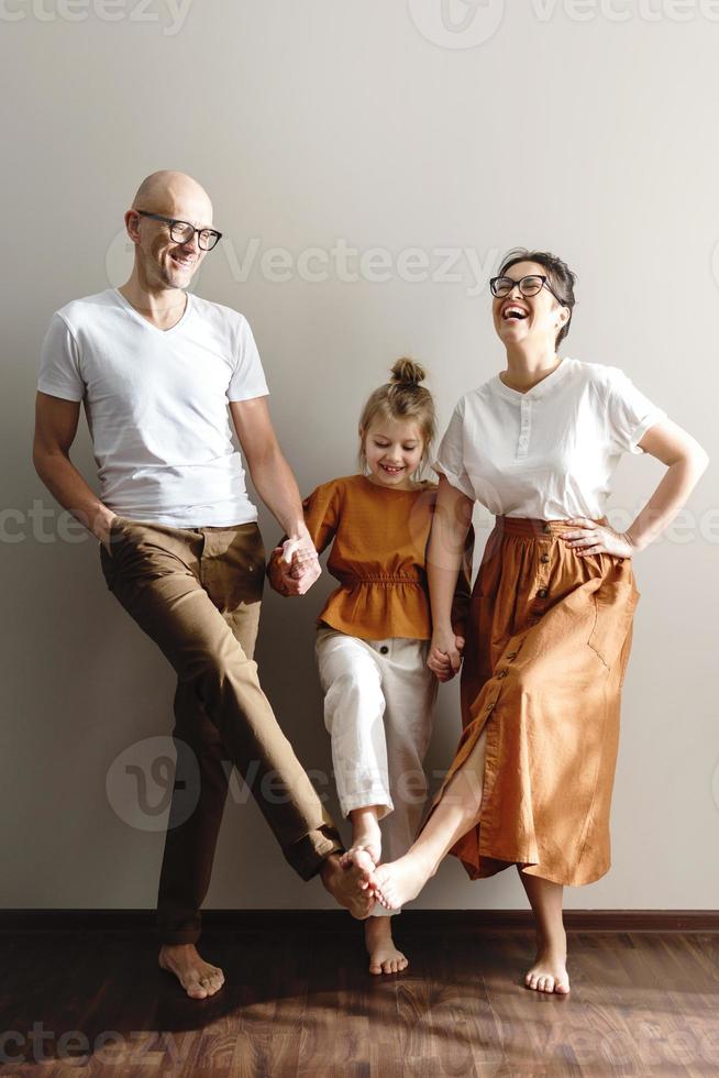 Young and happy family having fun at home photo