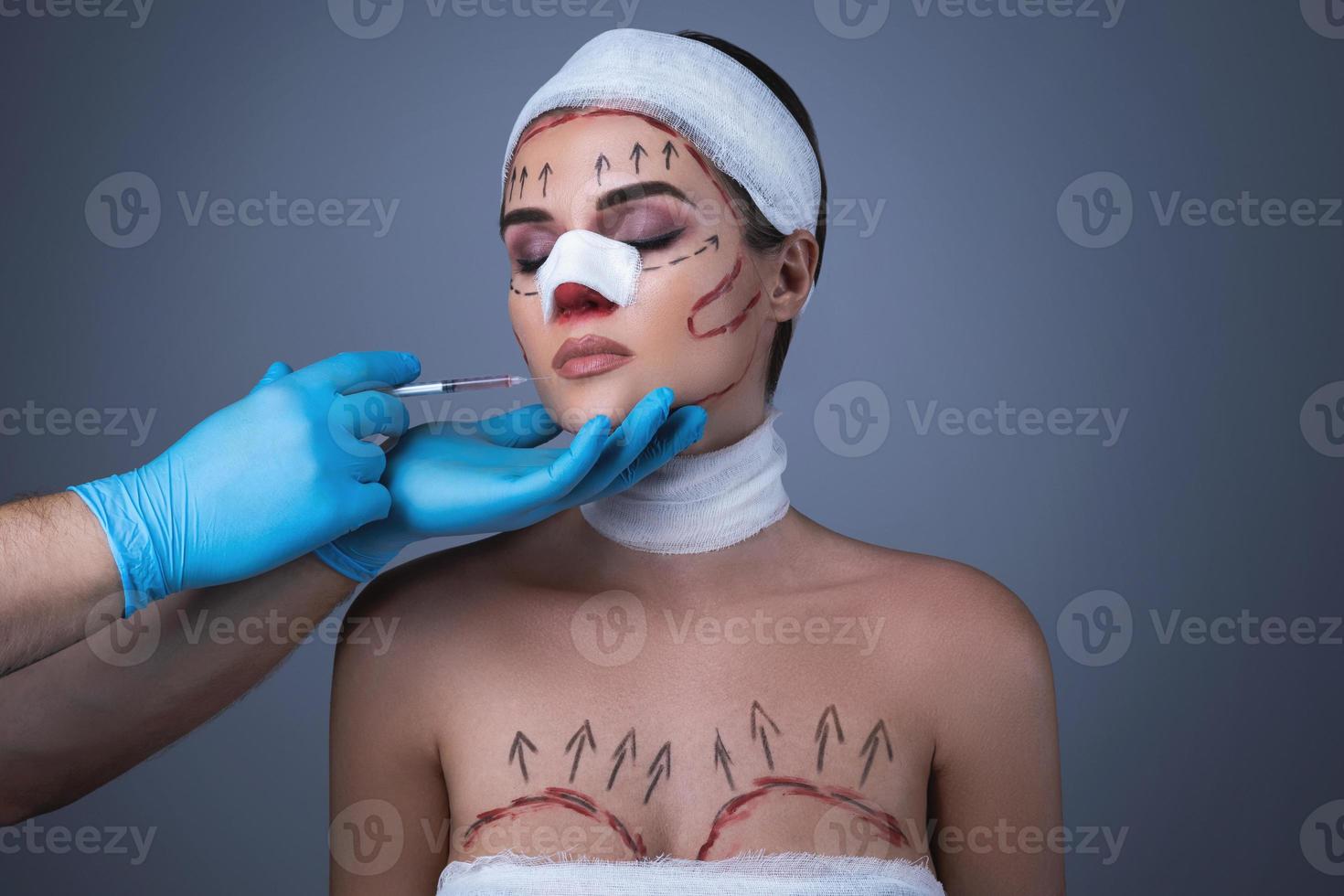 Woman wrapped with bandages and scars is prepared for another one operation. photo