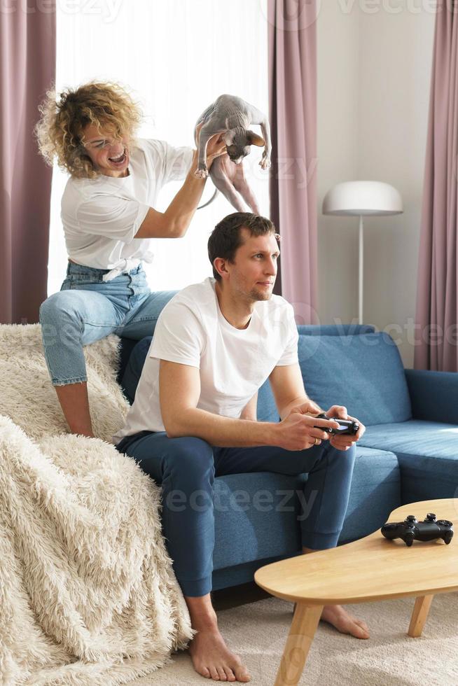 Young happy couple playing video game console photo