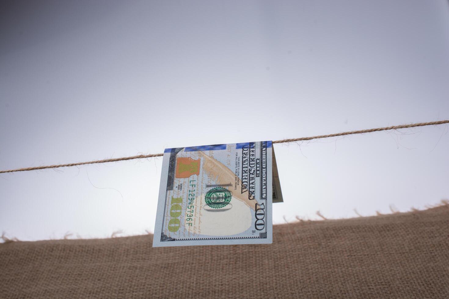 Banknote of US dollar hanging on a string 16238404 Stock Photo at Vecteezy