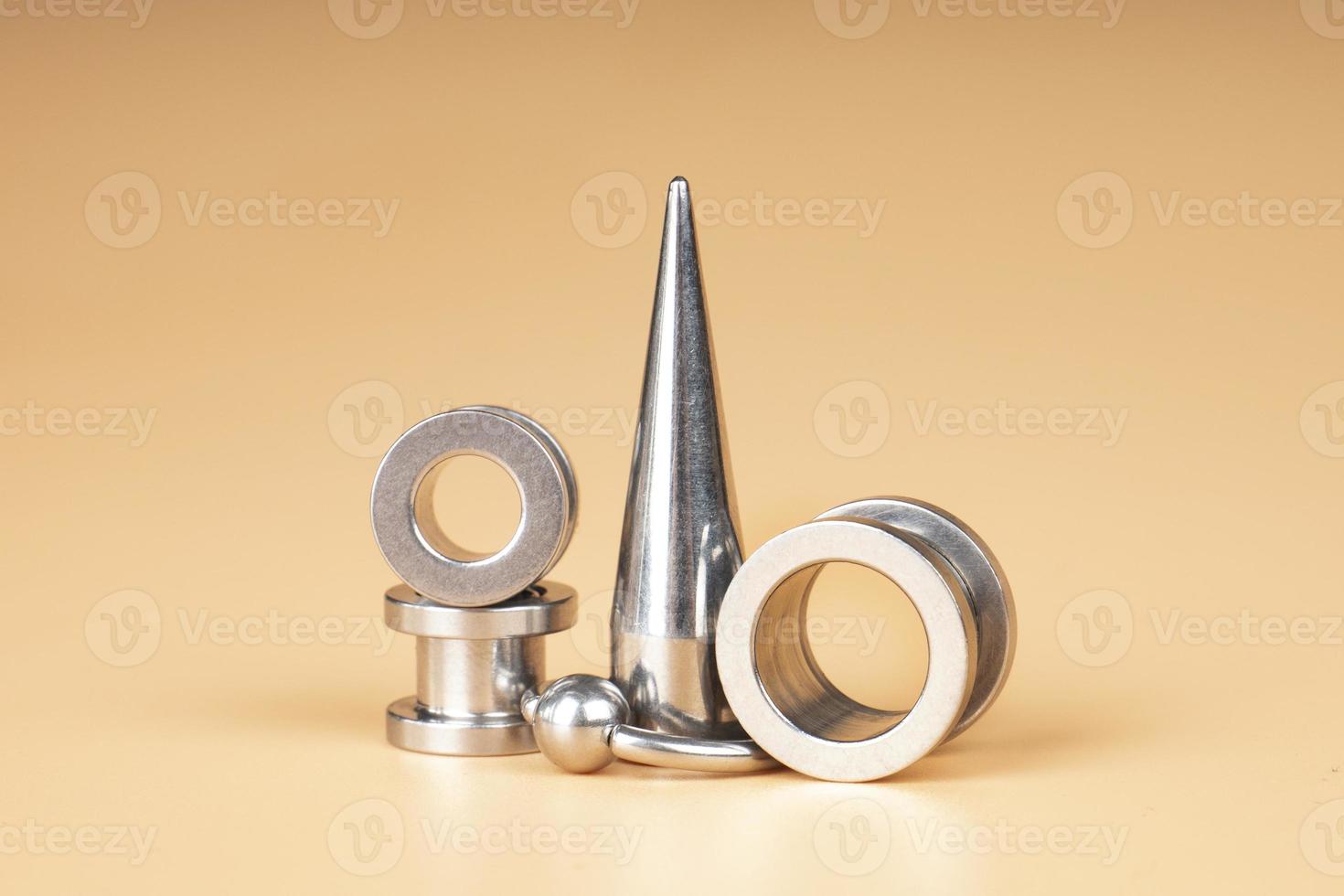 silver metal  tunnels , ear and tongue piercing accessories photo