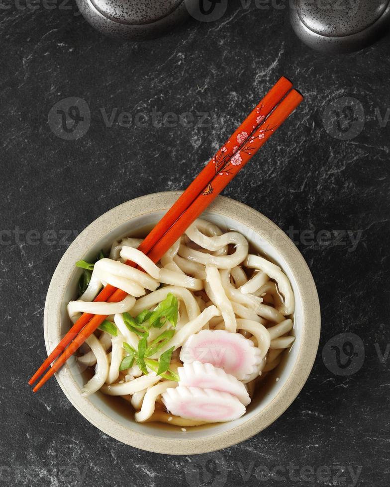 Top View Japanese Kake Udon with Narutomaki Topping photo