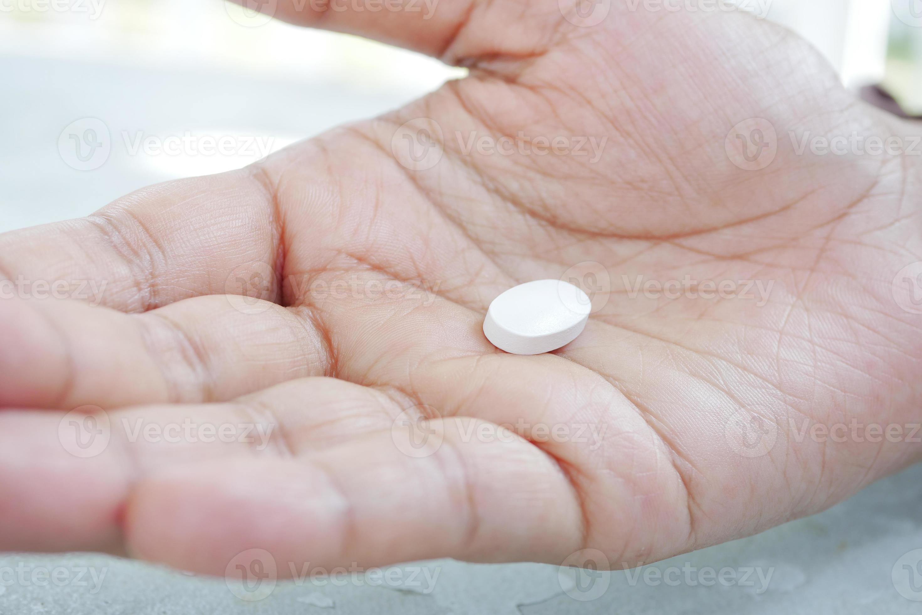 close up of medical pill on palm of hand 16243261 Stock Photo at Vecteezy