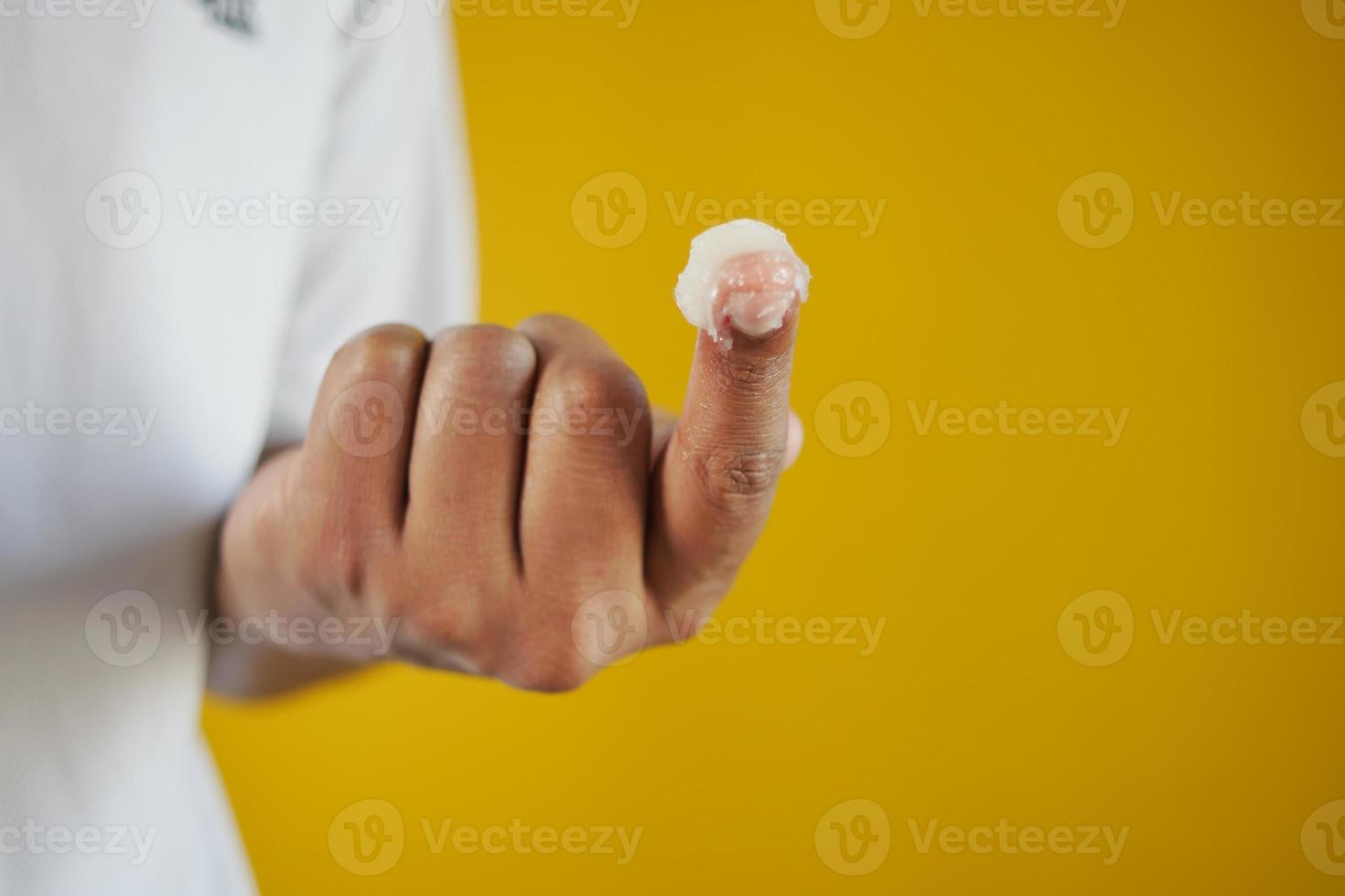 Close up of man hand using petroleum jelly photo