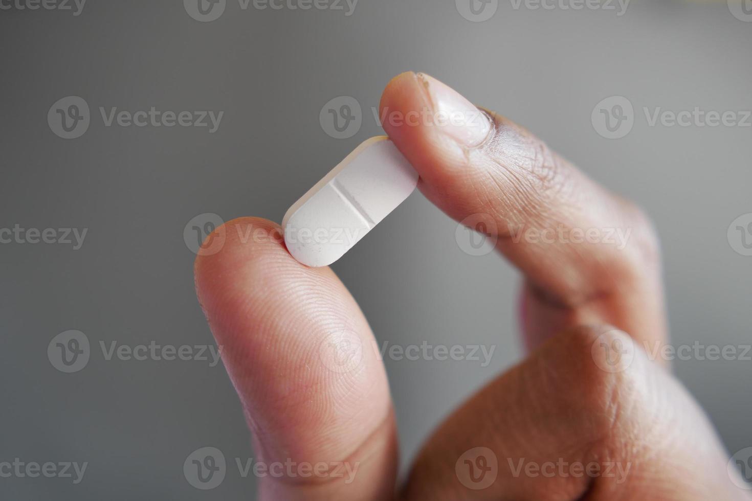 Close up of man hand holding pills with copy space photo