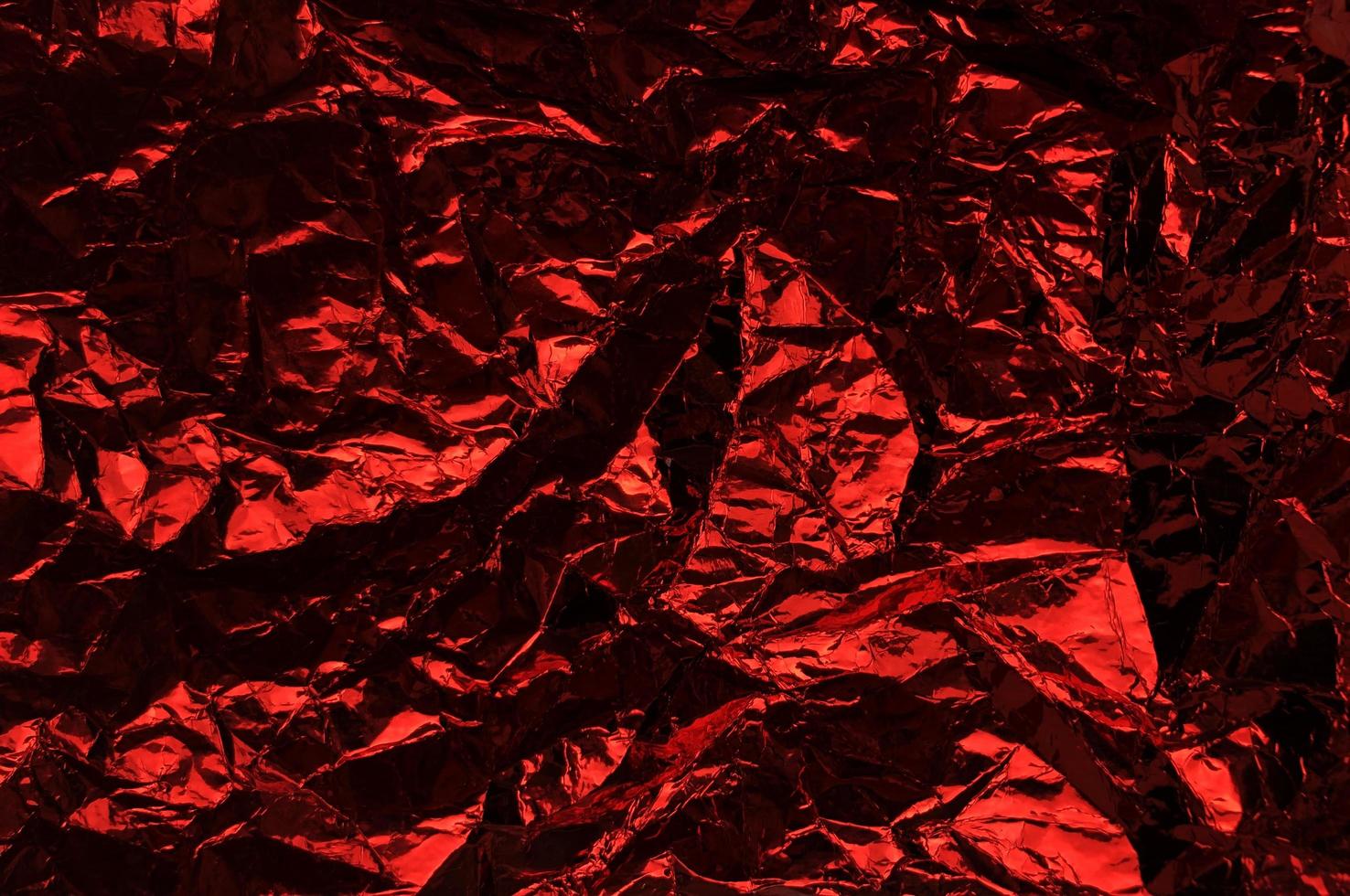 Crumpled plastic wrap texture in red color gradient for background and photo overlay effect