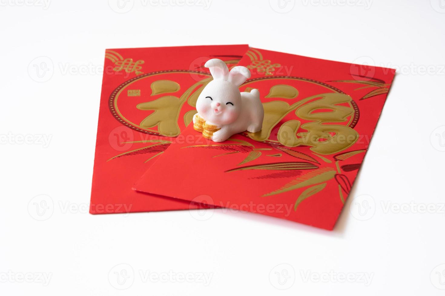 Chinese New Year of the rabbit festival concept. Rabbit on red envelopes isolated on white background. Happy New Year Chinese Rabbit 2023. Chinese character fu which stands for luck. photo