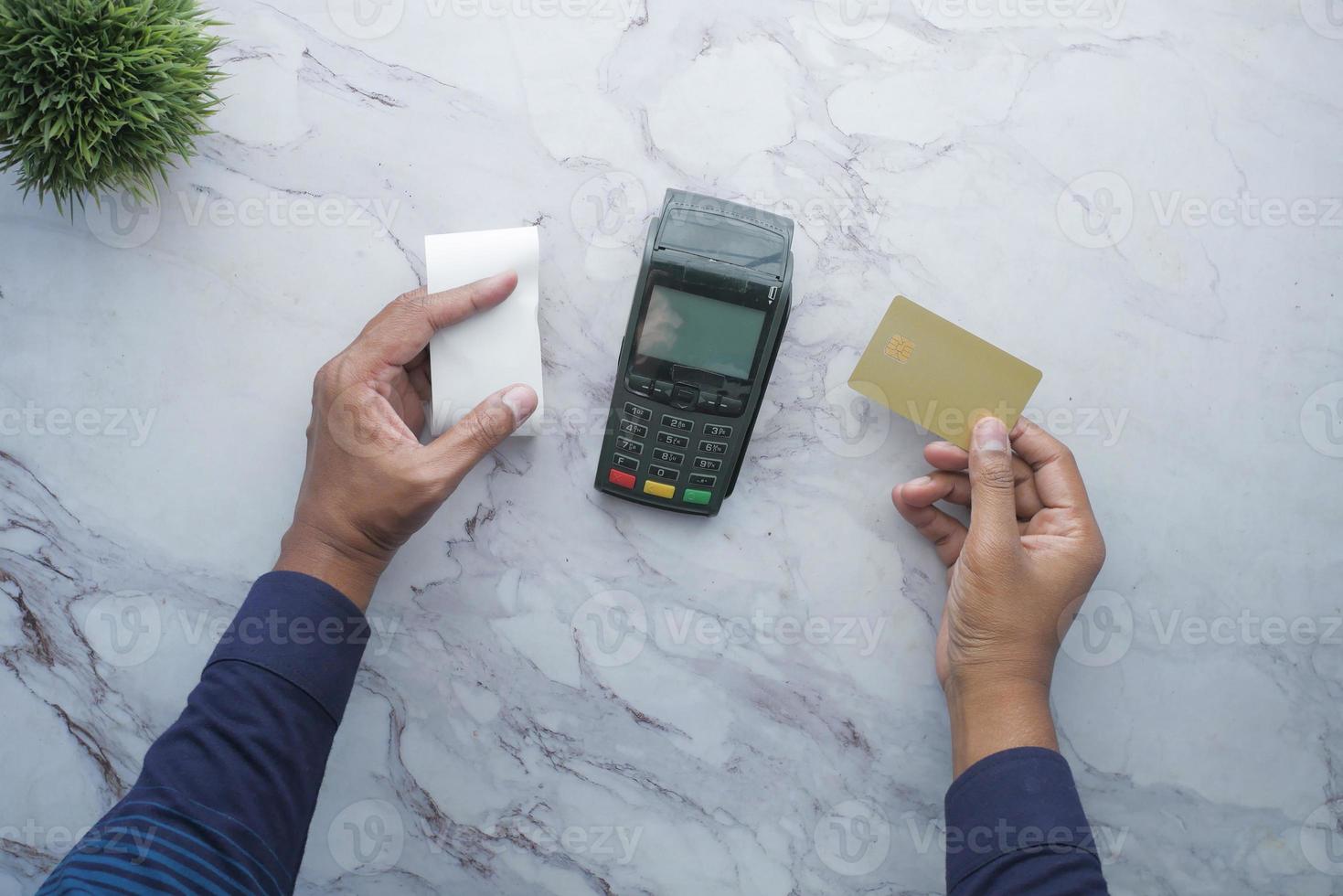 top view of men holding rolling paper and credit card photo