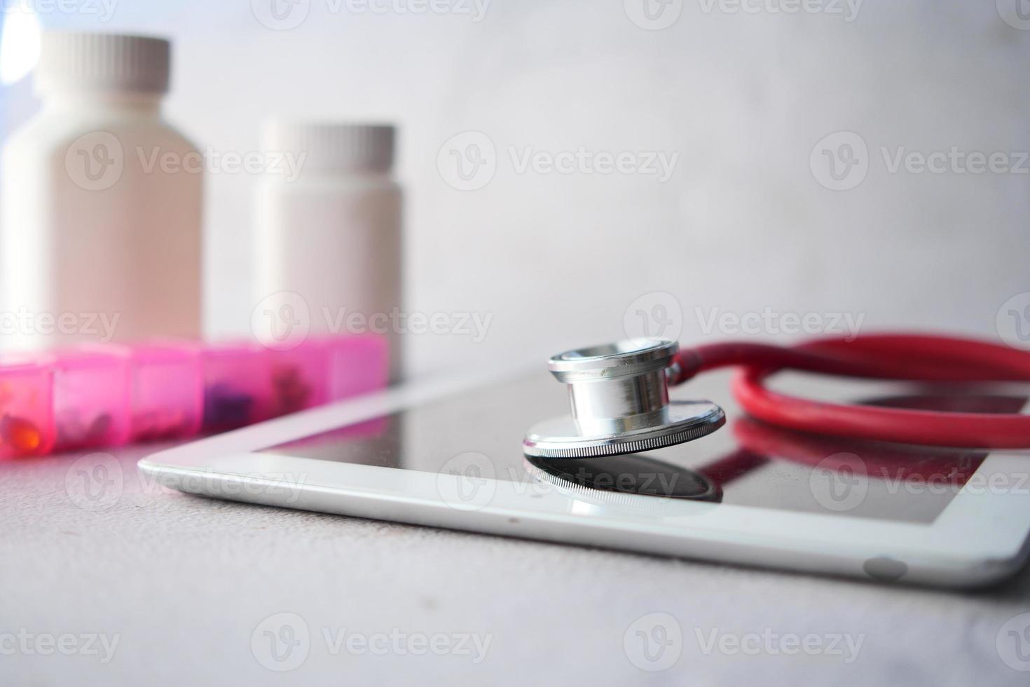 Medical Stethoscope On Modern Digital Tablet On White Background photo