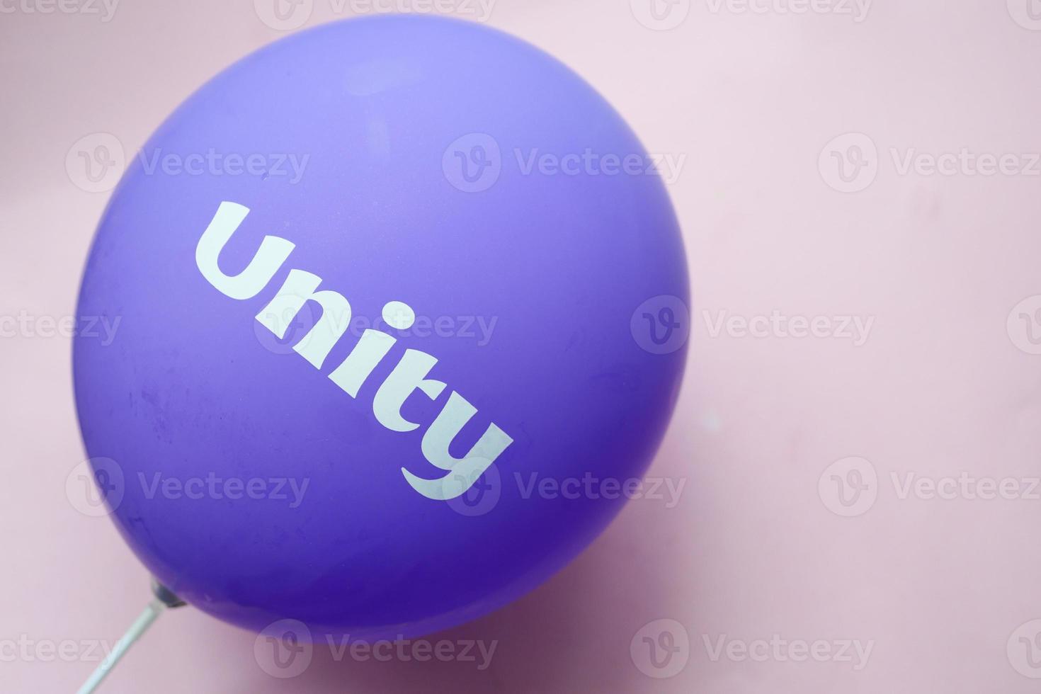 unity text on a purple color ballon, photo