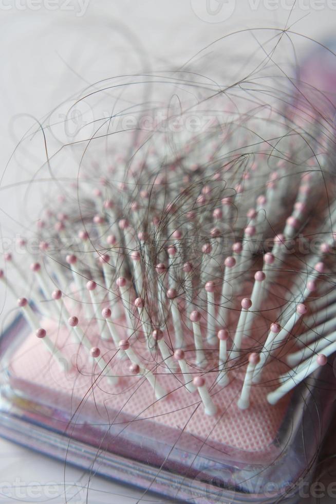 a brush with lost hair on table photo