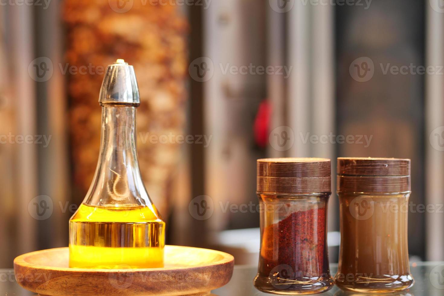 bottle of olive oil and spice on table photo