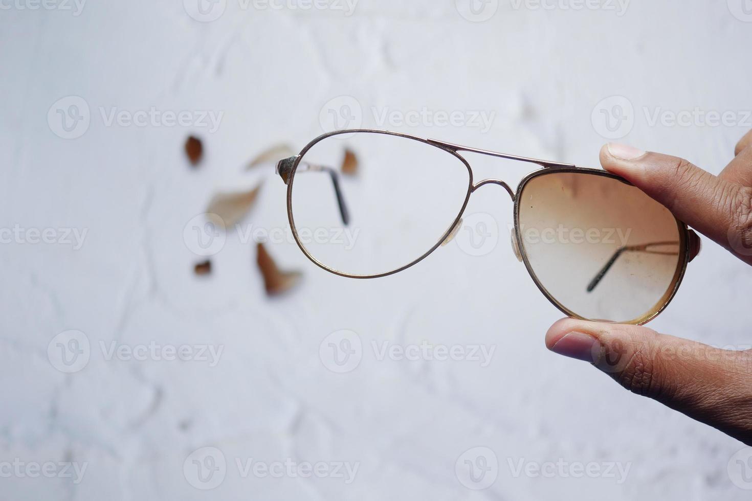 holding a broken eye glass top view photo