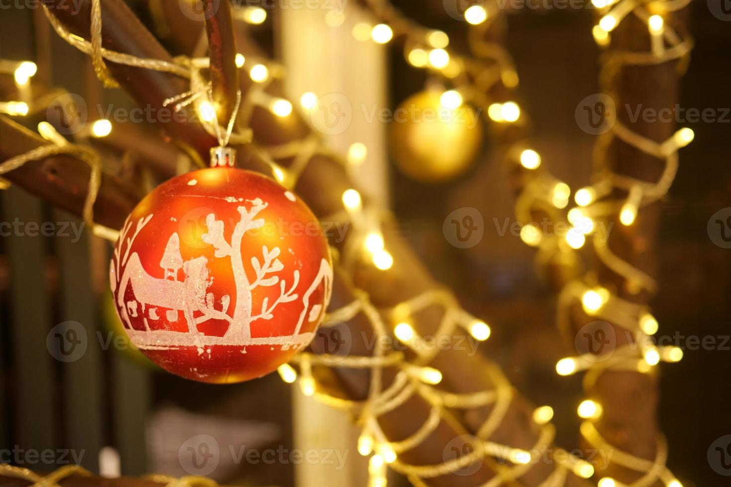 Christmas and New Year Decoration. Hanging Baubles close up. Abstract Blurred Bokeh Holiday Background. Blinking Garland. Christmas Tree Lights Twinkling. photo