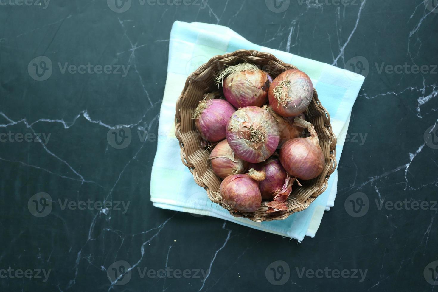 top view of fresh onion in a bowl on black background photo