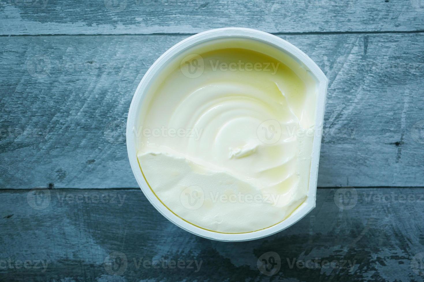 fresh butter in a container with bread on white background photo