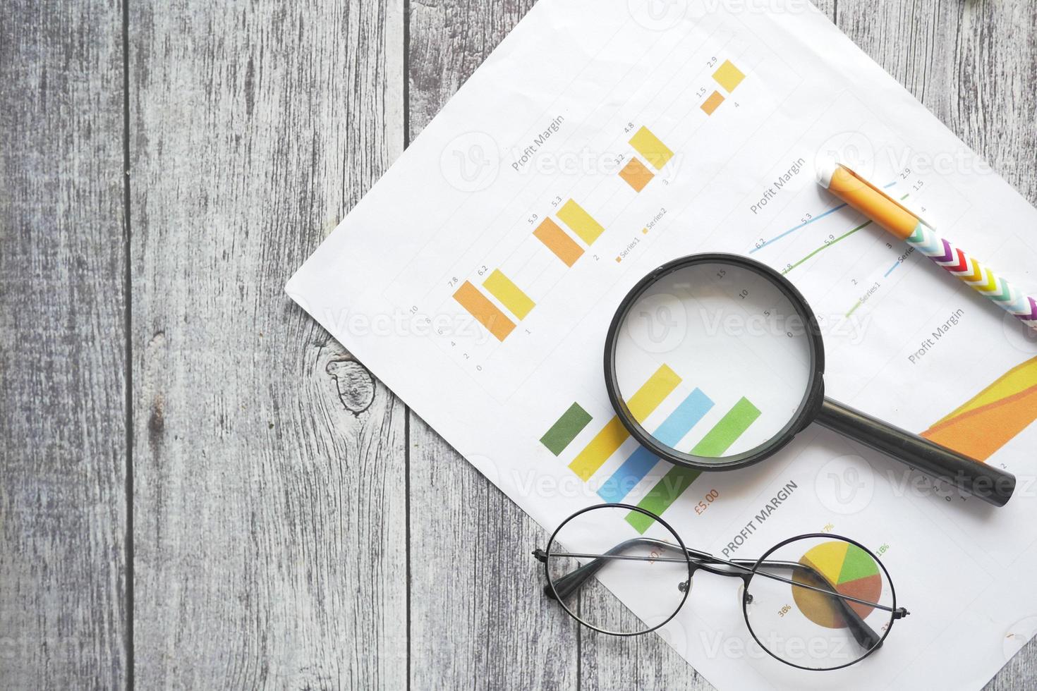 financial graph, calculator and notepad on table photo