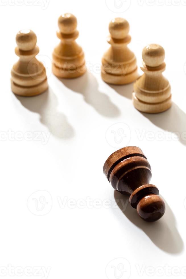 One black chess pawn among whites. Concept of racism and discrimination. photo