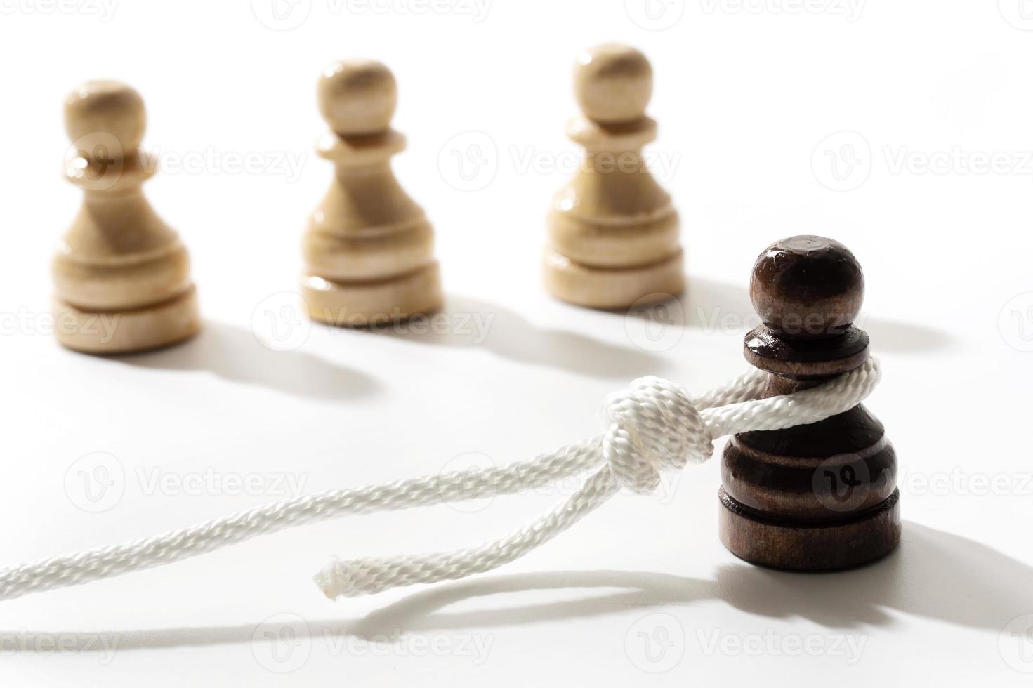 Black pawn with a hangman's loop on a neck photo