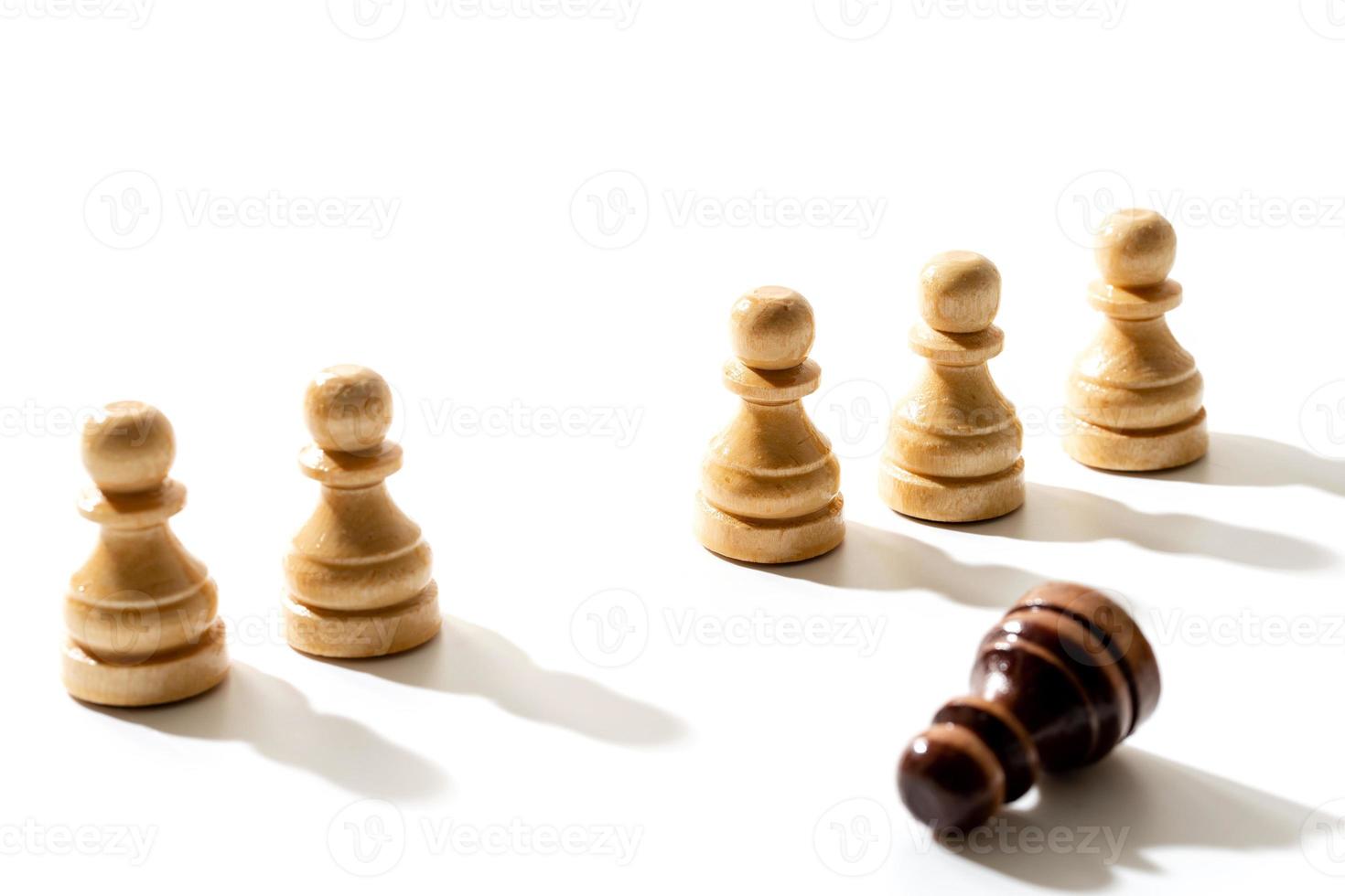 One black chess pawn among whites. Concept of racism and discrimination. photo